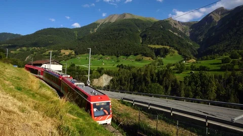 Red swiss train Bernina Express in Swiss Alps. Matterhorn Gotthard Bahn  Stock Footage 124551817