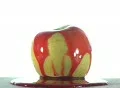 Red Syrup Lifts Off of an Apple Vídeos