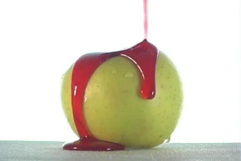 Red Syrup Pours Over an Apple Видео 293417