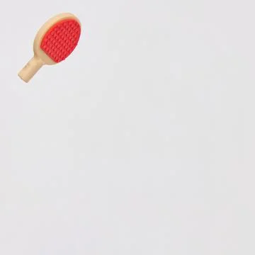 Red table tennis racket in the upper left on a white background with copy s.. Stock Photos
