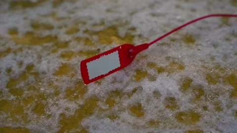 The red tag is lying on the snow 스톡 동영상 188542052