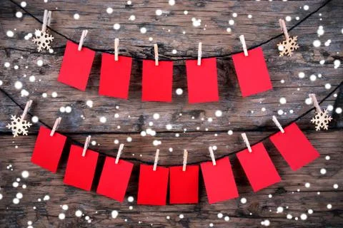 Red Tags with Copy Space Hanging in the Snow on Wooden Background Stock Photos