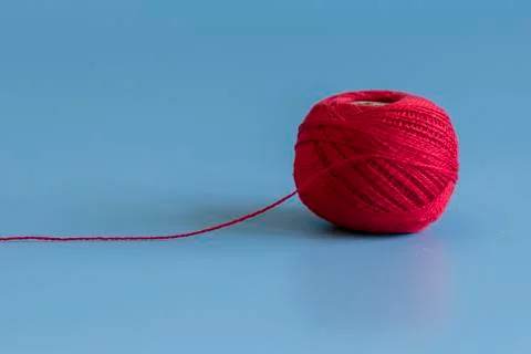 Red tangle of thread on a blue background Stock Photos