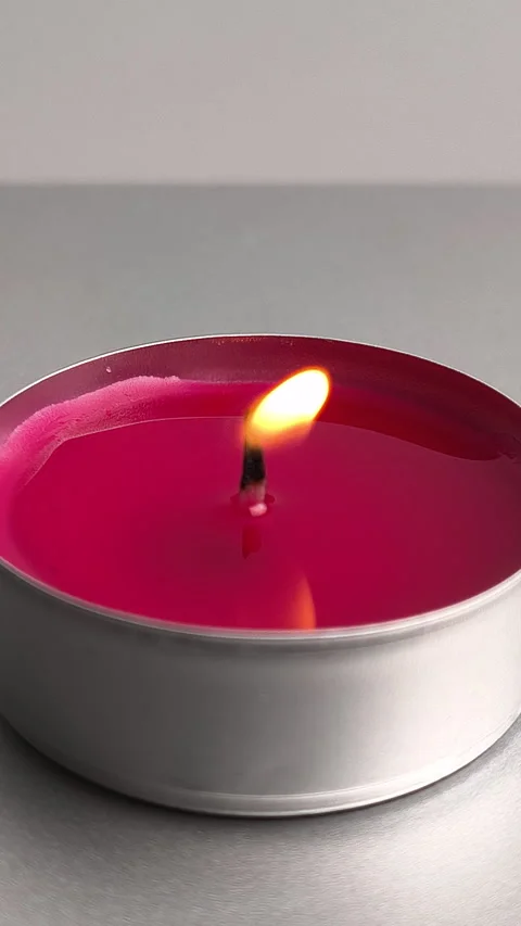 A red tealight candle is being lit with a lighter Stock-Footage 342176918