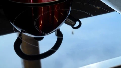 Red teapot on induction hob Video stock 74181061