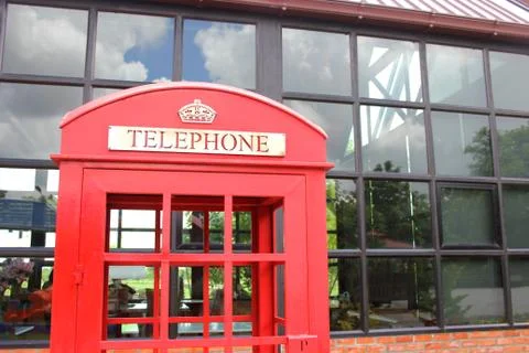 The red telephone booth is unique and beautiful. Stock Photos