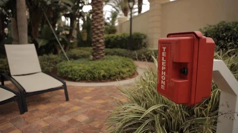 Red Telephone Box Next to Row of Pool Chairs Video stock 102573182