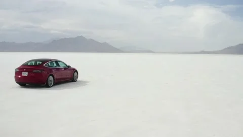 Red Tesla Model 3 drifting in Bonneville Salt Flats Stock Footage 132592133