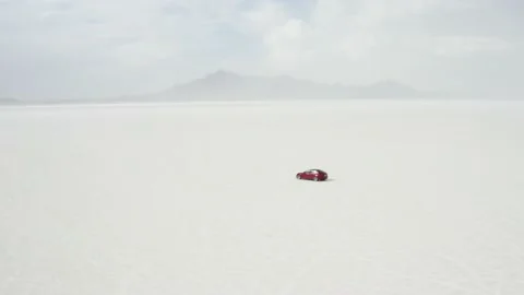 Red Tesla Model 3 drifting in Bonneville Salt Flats Stock Footage 132592167