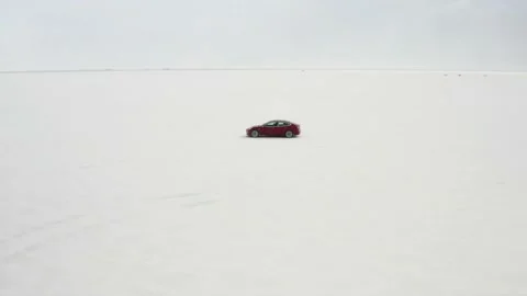 Red Tesla Model 3 drifting in Bonneville Salt Flats Stock Footage 132592208