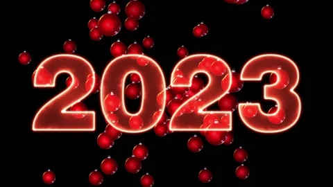 Red text 2023 animation and flying Christmas balls on black background Stock Footage 220697908