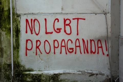 Red text on the concrete gray stone wall of the house. No LGBT propaganda Stock Photos
