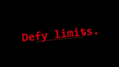 Red text defy limits appearing on plain black background for motivational Stock Footage 345499478