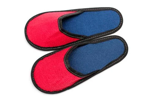 Red textile slippers with blue insole, house slippers isolated on white backg Stock Photos