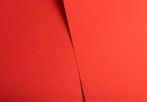 Red textured abstract background with a diagonal fold. Warm paper like surfac Photos
