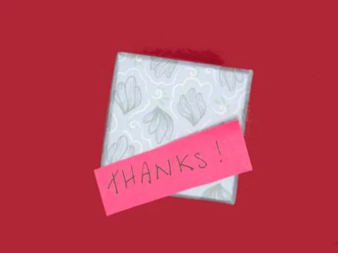 Red Thank You Post-it Note on a gift box on a red background Stock Photos