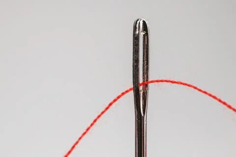 Red thread and needle on grey background Stock Photos