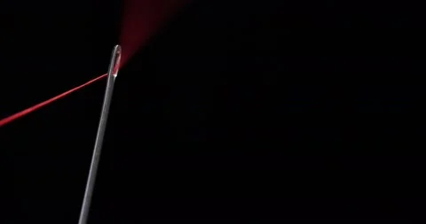Red thread going through needle eye, closeup Stock Footage 168364102