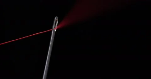 Red thread going through needle eye, closeup Stock Footage 168364108