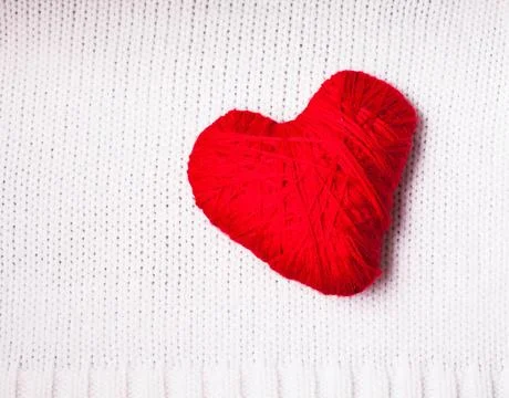 Red thread heart Red thread heart over knitted white textile. Valentine ba... Stockfoto's
