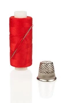 Red Thread Spool with Needle and Silver Thimble Close-up Isolated Stock Photos