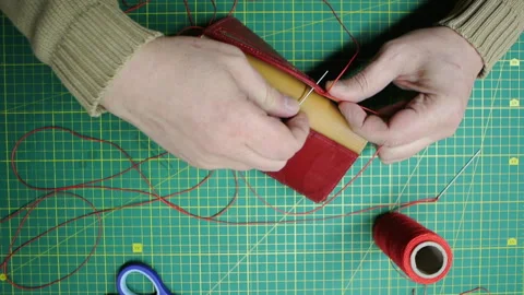 Red thread stitching leather red wallet DIY craft Stock-Footage 148048087