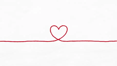 Red thread stretches across a white paper  to form a heart Video stock 341497095