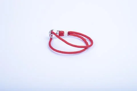 Red thread, string as an amulet for wrist isolated on white. Stock Photos