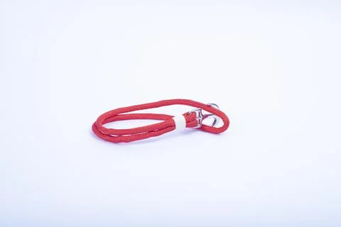 Red thread, string as an amulet for wrist isolated on white. Stock Photos