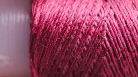 Red threads from natural silkworm. Factory winding on a plastic sleeve. Real tim Stock Footage 129148984