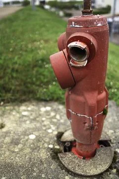 Red three outlet fire hydrant pillar for fire engine connection in Dijon Fran 库存照片