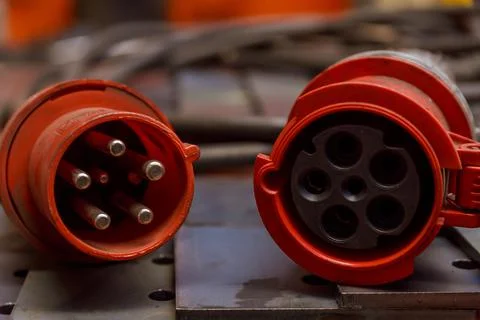 Red three-phase plug and socket with cable. 380 volts. Stock Photos
