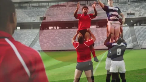 Red thrower tossing ball, red and navy lifters hoisting jumpers, vying for ball Stock Footage 311504816