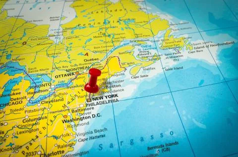 Red thumbtack in a map, pushpin pointing at New York city Stock Photos