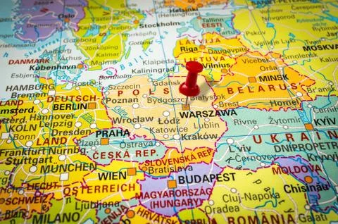 Red thumbtack in a map, pushpin pointing at Warsaw city Stock Photos