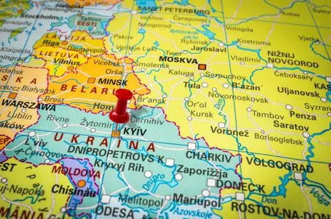 Red thumbtack in a map, pushpin pointing at Kiev city Stock Photos
