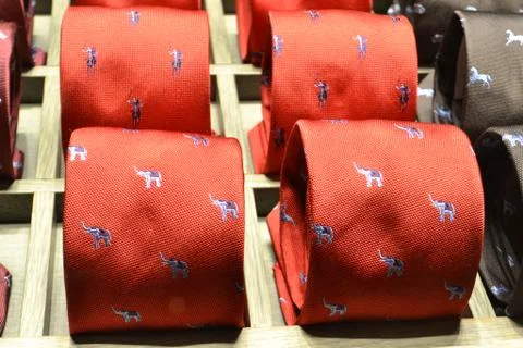 Red ties with elephant drawing pattern for sale in fashion boutiques. Stock Photos