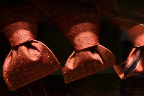 Red ties in polka-dot pattern for sale in fashion boutiques. Stock Photos