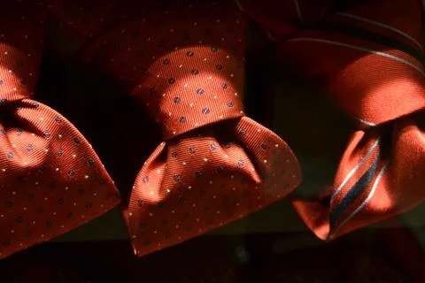 Red ties in polka-dot pattern for sale in fashion boutiques. Stock Photos