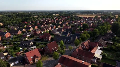 Red-tile rooftops cluster densely across quiet German village at golden sunset Stock Footage 340566111