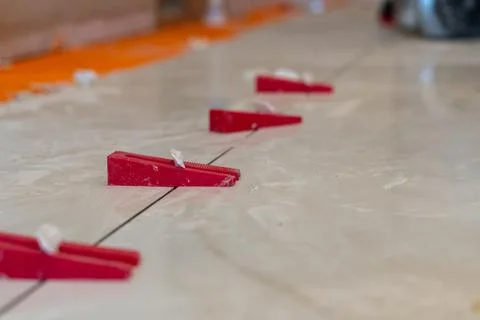 Red Tile Spacers on Construction Site Stock Photos