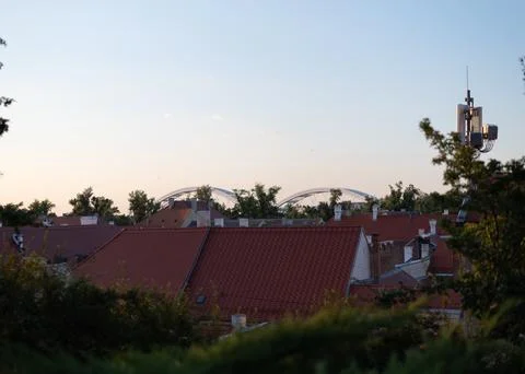 Red-tiled rooftops of Petrovaradin are visible behind green foliage Stock Photos