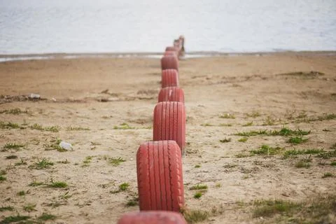 Red tires on the beach Stock Photos