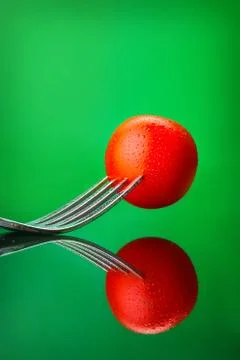 Red tomato on fork Stock Photos