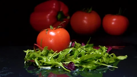 Red tomato with green tail drops on mixed salad Stock Footage 239914209