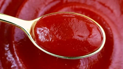 Red tomato ketchup in the spoon with circle rotation close up Stock Footage 244301952