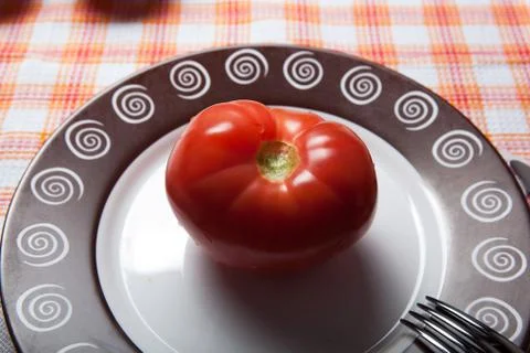Red tomato on a plate Stock Photos