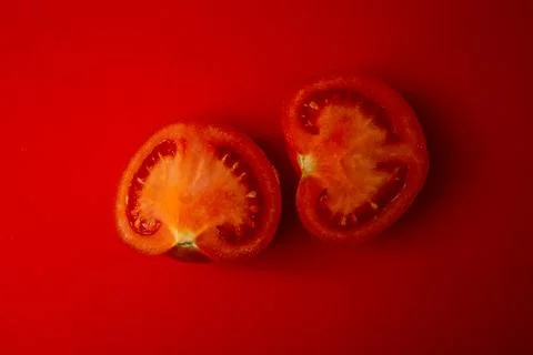 Red tomato on a red background Stock Photos