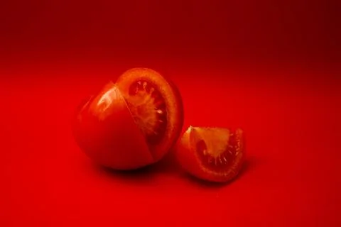Red tomato on a red background Stock Photos