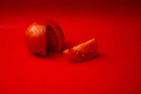 Red tomato on a red background Stock Photos